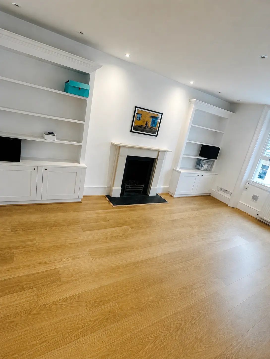 Engineered oak flooring in a lounge with a white fireplace