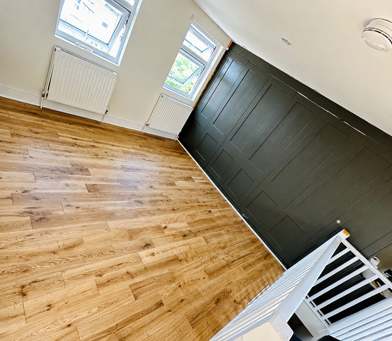 Warm engineered oak flooring installed in a Watford home