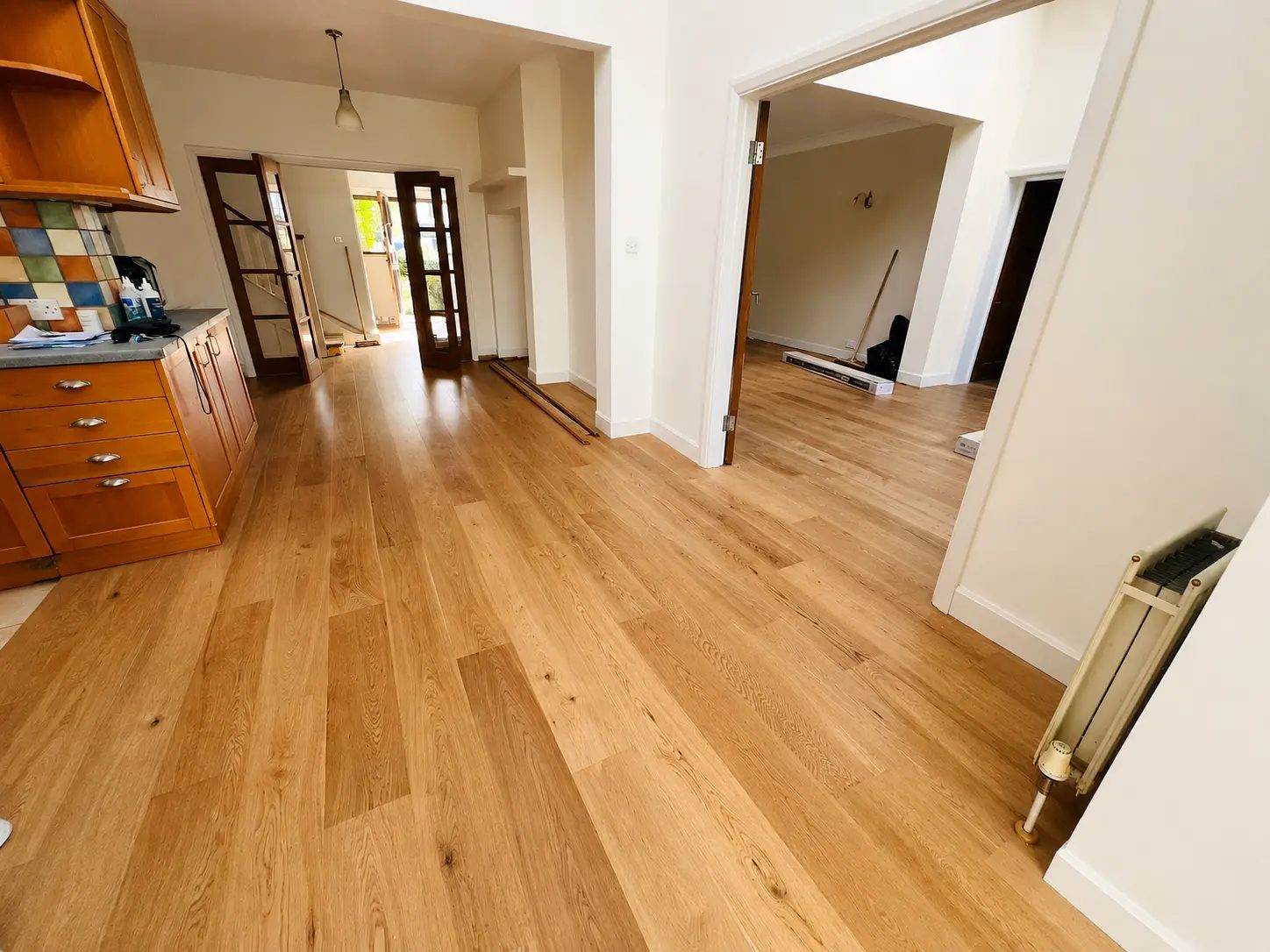 Light oak engineered wood flooring in an open-plan kitchen