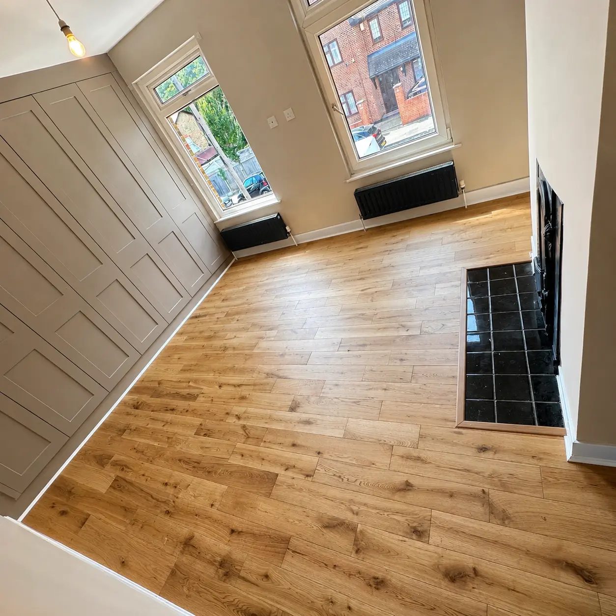 Warm oak flooring with built-in wardrobes and tiled hearth, Watford