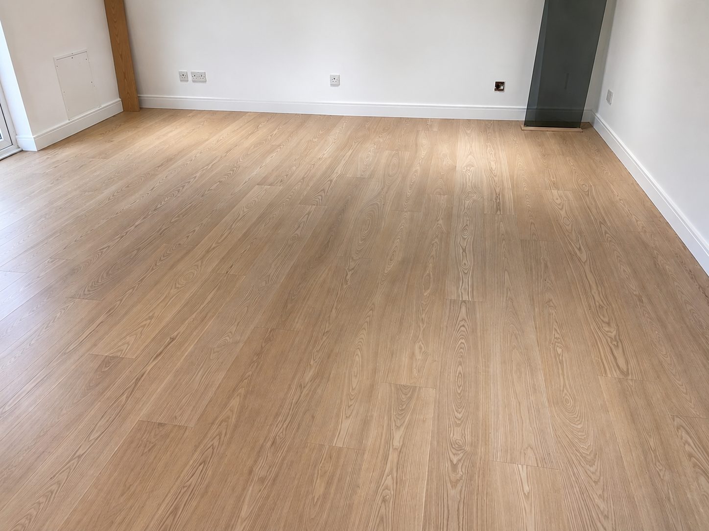 Wide-plank natural rustic oak flooring in a bright room