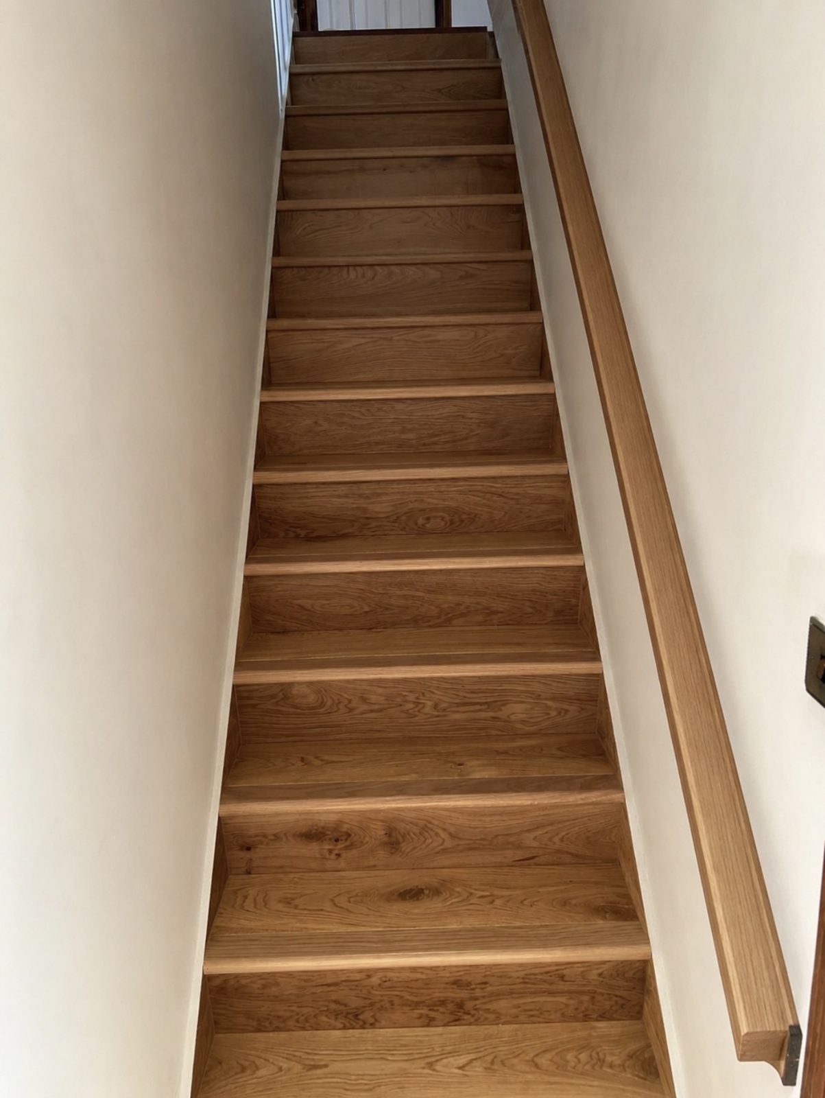 Narrow staircase finished with light oak treads